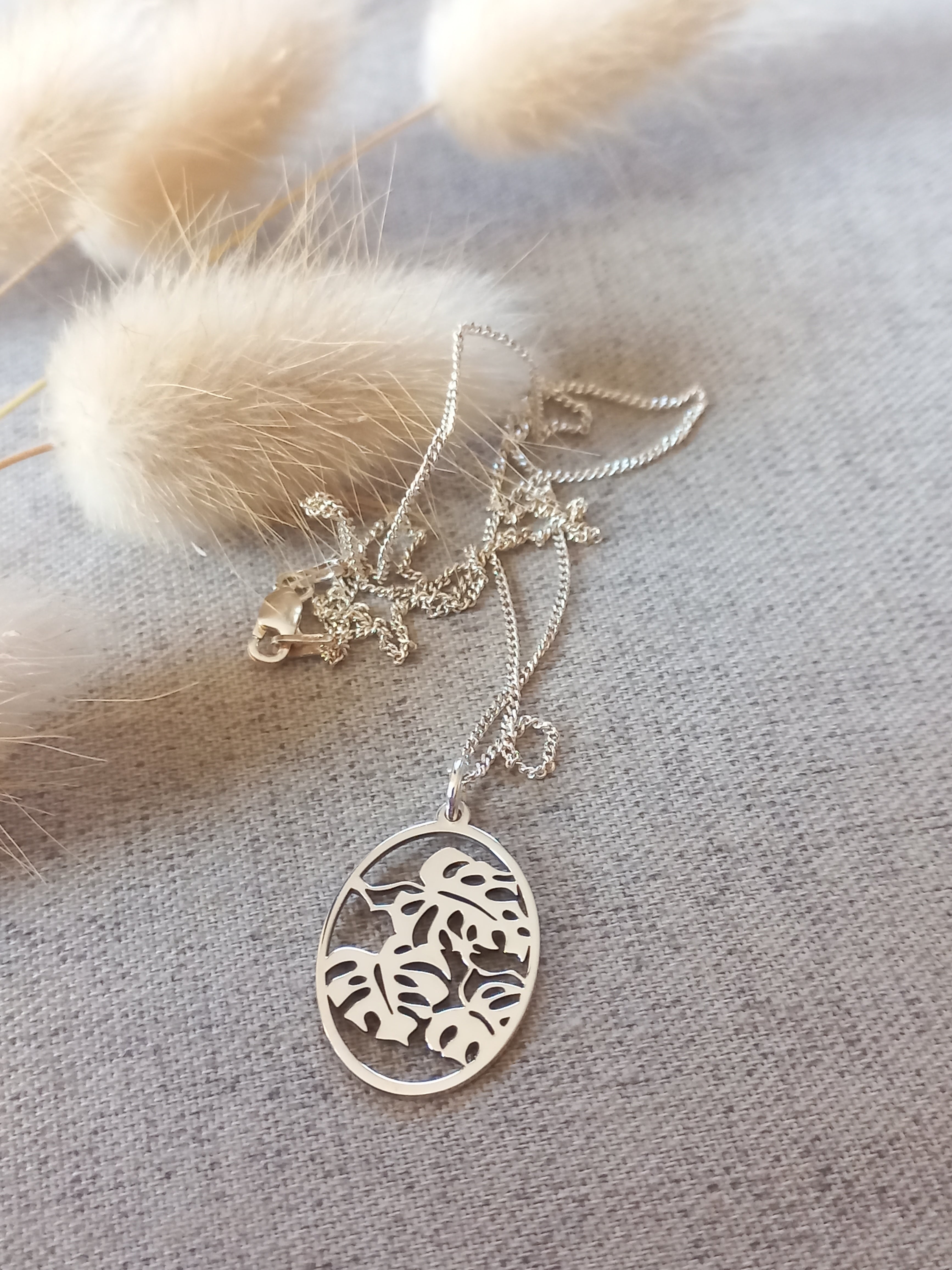 Monstera leaves oval cutout pendant