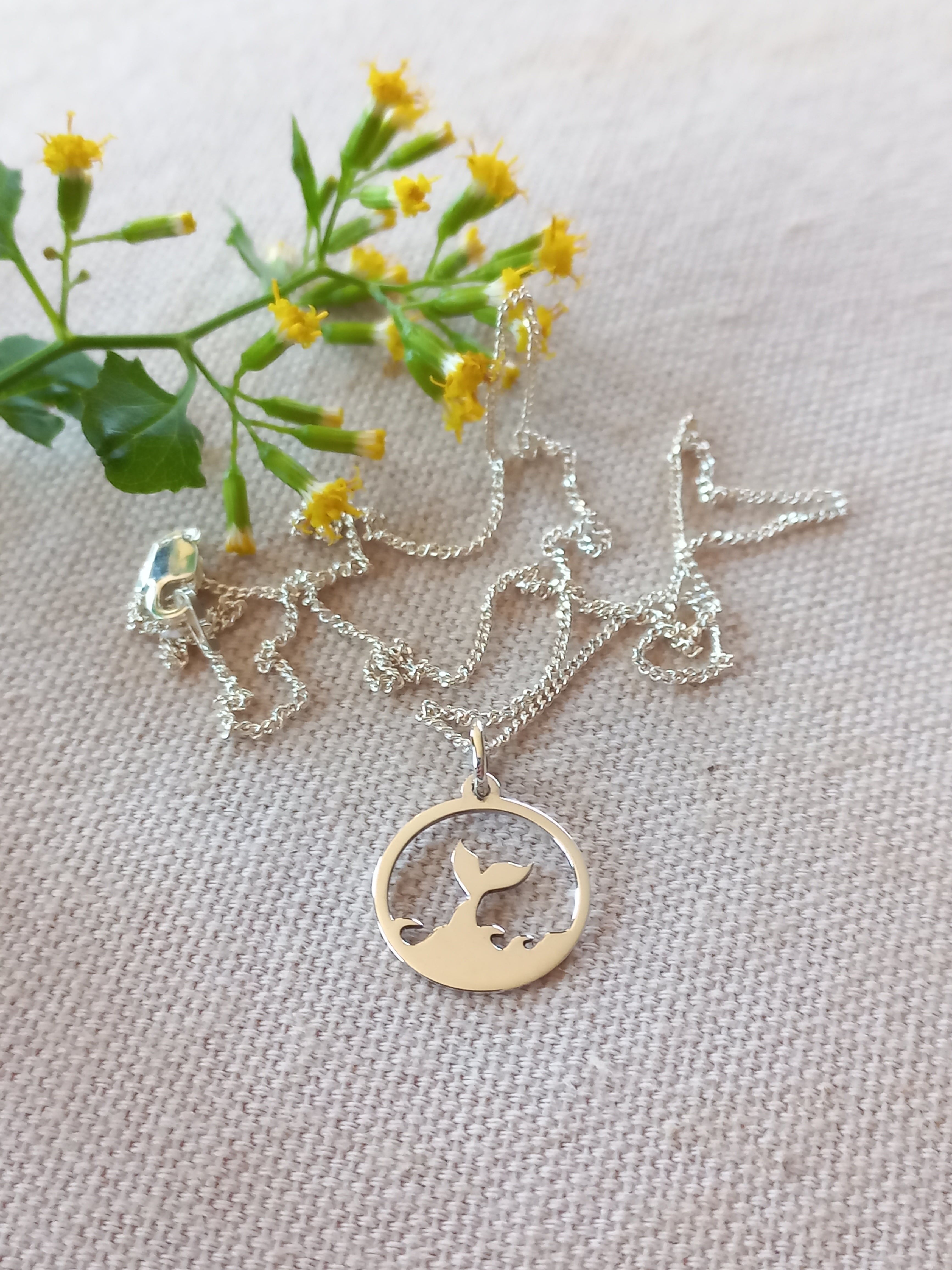 Whale tail circle cutout pendant