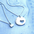 Silver mother daughter set with a 20 mm disc with a 10 mm cutout heart as separate pendant. Custom engraving can be placed on the disc up to 20 letters and on the heart up to 10 letters.