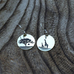 There are few things as striking as the sun setting over the African Savannah.  These earrings capture the beauty of the sun setting behind an Acacia tree combines with the elegance of the giraffe.  These earrings can be manufactured in silver, copper, brass or 9ct gold.  Disc size: 18 mm  All earrings are made with silver hooks, for gold hooks with the gold discs (only yellow or white gold) please inquire about the price.