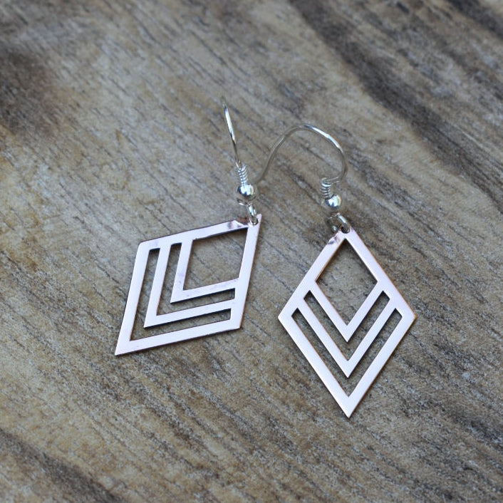Three rhombus shapes of different sizes on top of another.  These earrings can be manufactured in silver, copper, brass or 9ct gold.  Disc size: 25 x 16 mm  All earrings are made with silver hooks, for gold hooks with the gold discs (only yellow or white gold) please inquire about the price.