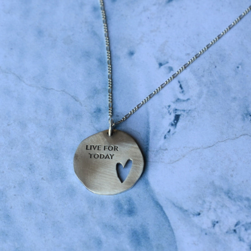 Silver 20 mm free form disc with a personalised motto or slogan engraved on in the font of your choice. This disc is available with or without the heart cutout.