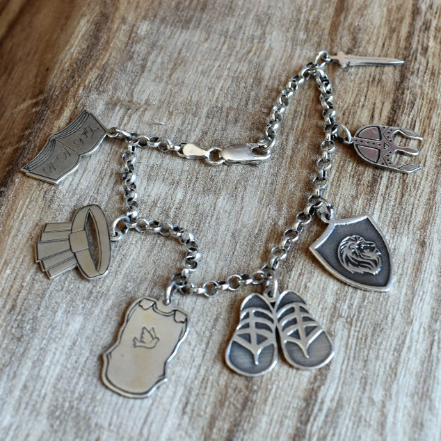 Charm bracelet with the Christian armour as described in Ephesians 6:10-18 lasercut and engraved in Argentium silver on a 3 mm sterling silver bracelet. The average length of the individual charms is 20 mm.
