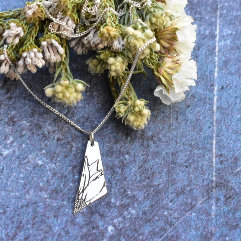 Elongated sunflower pendant