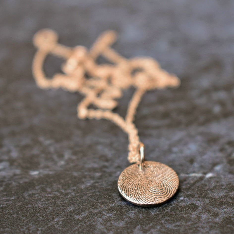 Fingerprint engraved disc pendant